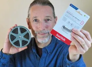 Nathaniel holding 8mm reel and showing USB stick